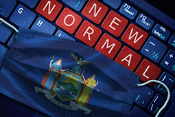A keyboard with the keys, NEW NORMAL, in red and a face mask imprinted with the New York State seal