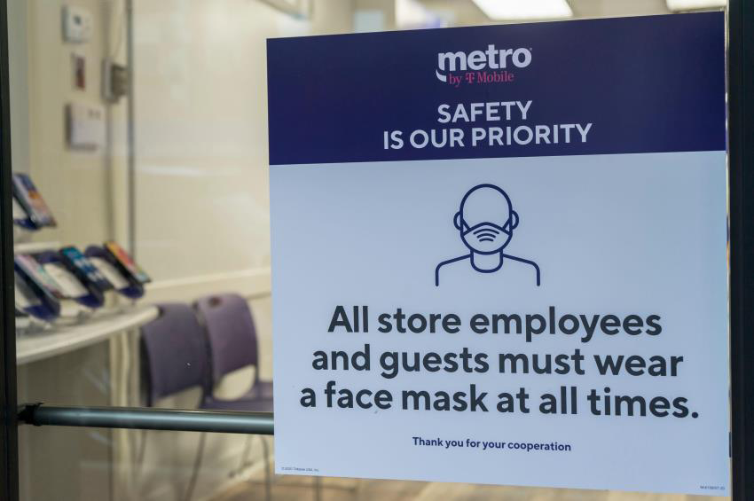 Sign in a cellphone store window stating, Safety is Our Priority, and declaring, 