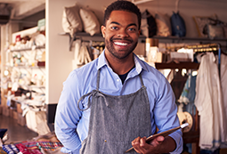 Smiling African American businessman holding computer tablet