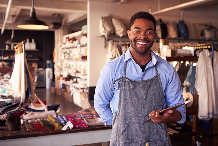 Smiling African American businessman holding computer tablet