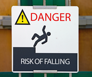 Photo of a warning sign with the words 'Danger' and 'Risk of Falling' including an icon of a person falling