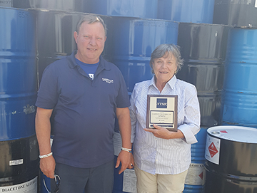 Doug Harbison and Patricia Potts holding plaque recognizing Harbison Brothers Inc for 80 years as a NYSIF customer