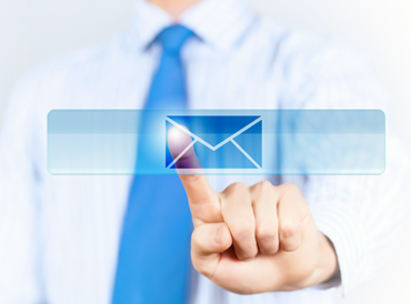 Index finger of a business man in a tie touching an on screen Image of an envelope